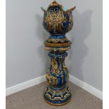 A reproduction majolica pottery Jardiniere and Stand, stand is damaged with a chip,  W 47cm x H