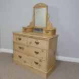 A vintage pine Dressing Table, with shaped mirror flanked by two small drawers, on a base with three