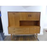 A mid 20thC G-Plan 'Fresco' teak Sideboard, with two drawers, two drop down sections and a cupboard,