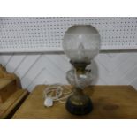 A brass and cut glass Oil Lamp, having a cut clear glass font and frosted shade, on plinth base,