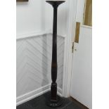 A Victorian carved mahogany torchere, with a screw on circular top mounted on a reeded column and