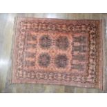Tribal rugs; an Afghan Rug, hand-knotted with tekke and geometric designs on a light red ground,