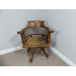 An early 20thC swivel Desk Chair, with spindle back and scroll arms, above an upholstered pad