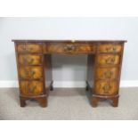 An early 20thC walnut Serpentine-fronted Pedestal Desk, the top with green tooled leatherette inset,