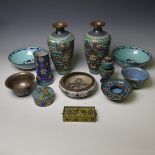 A pair of oriental painted enamel Bowls, decorated in the famille rose palate with flowers on a pale