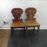 A pair of 19thC mahogany shell back Hall Chairs, W 45cm x H 86cm x D 45cm, one with legs slightly