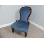 A Victorian walnut nursing chair, upholstered in blue fabric, W 58cm x H 92cm x D 75cm.
