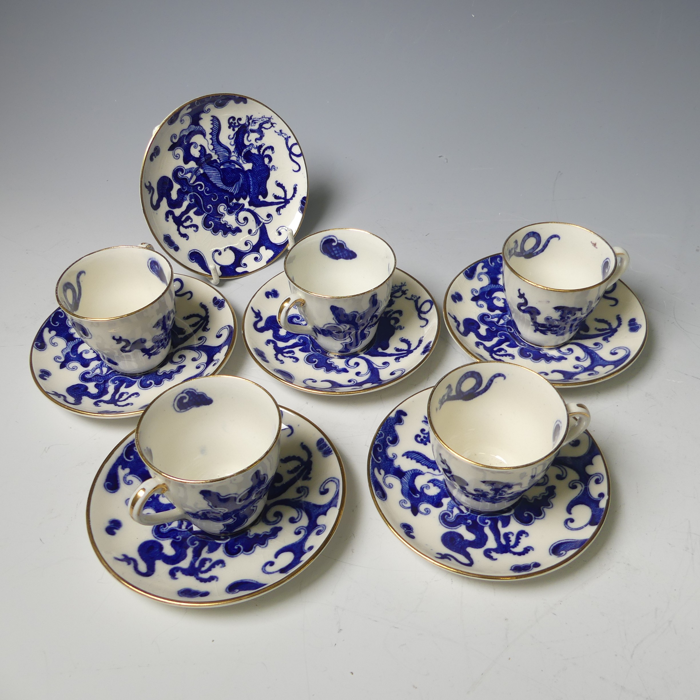 A Royal Worcester chinoiserie dragon pattern part Coffee Set, comprising four Cans and six
