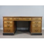 An Edwardian oak twin Pedestal Desk, the tooled leather top above three frieze drawers with three