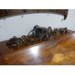 A decorative cannon together with approx twenty more decorative smaller cannons, W18.5cm x H 18cm