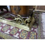 A brass fire fender with ornate gallery, 133cmL x 36cmD x17H.