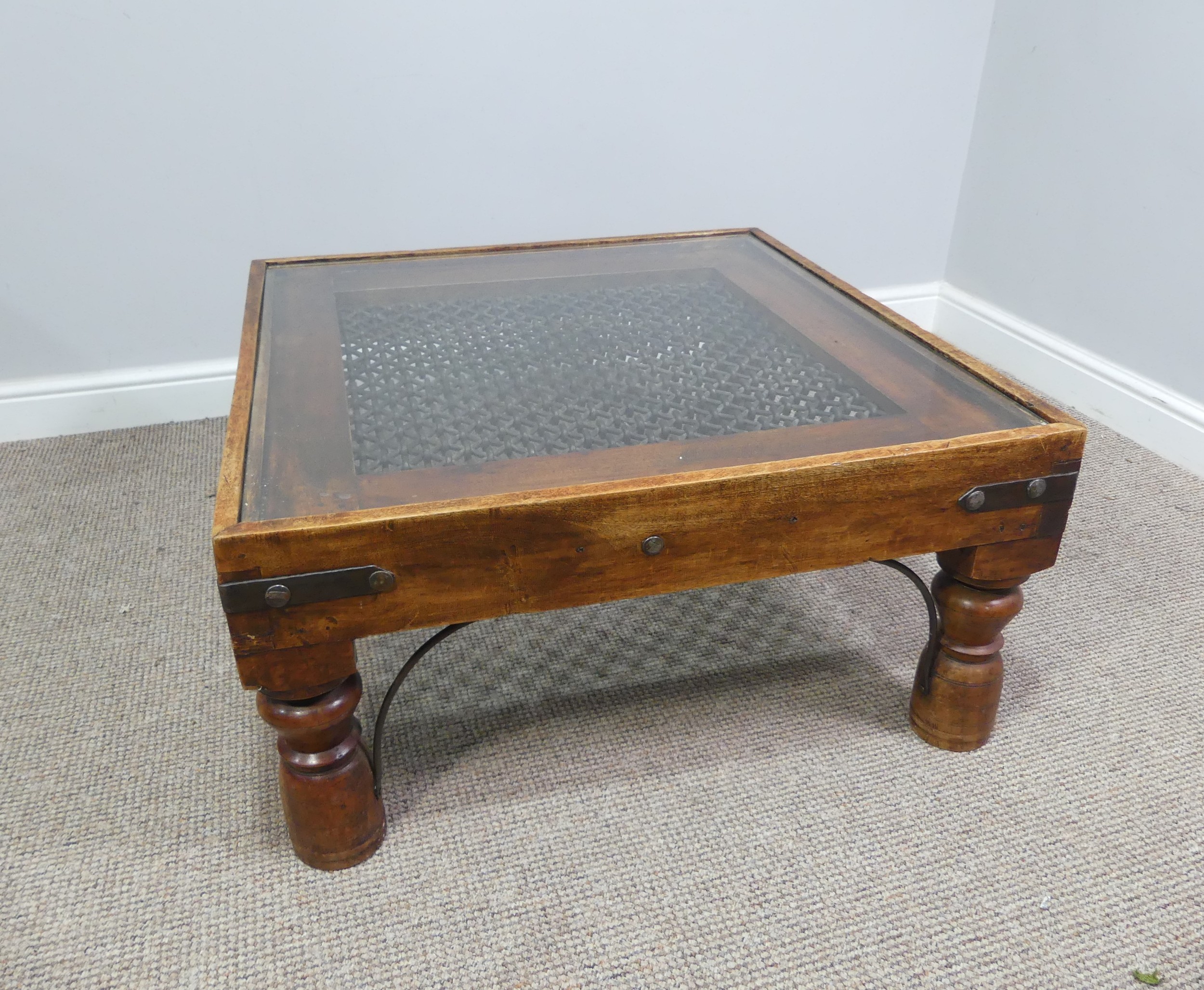 A 20th century rustic style oak and iron Coffee Table with glass top, W 80cm x D 80cm x H 40cm.