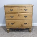 A pine Chest of Drawers, comprising two short over two long drawers, raised on turned feet, W 89cm x