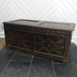 An 18th century oak two-panel Coffer, with carved decoration on front and side panels, W 118cm x H