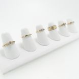 Six 9ct gold Rings; variously set including one channel set ten small diamonds, Size J, a single