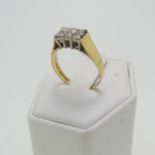 An 18ct gold and diamond Ring, the six brilliant cut stones in two rows, estimated total diamond