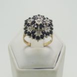 A sapphire and diamond cluster Ring, the cluster 17.5mm wide, all mounted in 9ct yellow and white