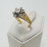 A diamond cluster Ring, with illusion set diamonds in white gold, on textured 18ct yellow gold