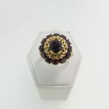 A garnet cluster Ring, mounted in 18ct yellow gold, Size O½, total weight 7g.