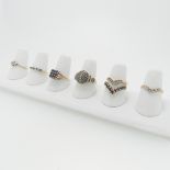 A collection of seven 9ct gold Ring; variously set including one with nine sapphires in squared