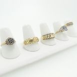 A 9ct gold Ring, the textured front with a row of diamond points above and below, Size T,together