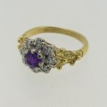 An amethyst and diamond cluster Ring, the circular facetted amethyst within a surround of diamond