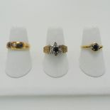 A small 18ct yellow gold, sapphire and diamond three stone Ring, in open circular mount, Size M,