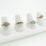 A small three stone diamond Ring, set on the cross in 9ct yellow gold, Size L, together with a small