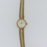 An Omega 9ct gold lady's dress Wristwatch, the circular dial with gilt baton markers, on 9ct gold