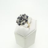 A sapphire and diamond cluster Dress Ring, mounted in 9ct yellow and white gold, Size M, approx