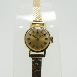 A lady's Tissot Wristwatch, with champagne dial and baton markers, in a gold plated case with