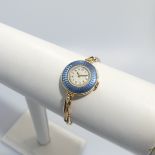 An 18ct yellow gold lady's Wristwatch, with Swiss 15-jewels movement, the white enamel dial with