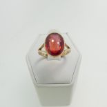 A 9ct yellow gold Ring, set with an oval facetted red stone, possibly ruby, 11.8mm x 9.3mm,