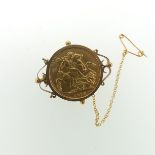 A George V gold Sovereign, dated 1915, in a 9ct gold brooch mount, gross total weight 10.7g.