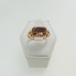 An antique style Ring, set with a rectangular facetted orange stone, closed back and with engraved
