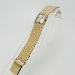 A 9ct yellow gold Record DeLuxe lady's Wristwatch, the square silvered dial with Swiss 17-jewels