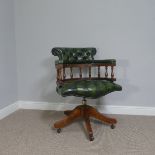 A reproduction buttoned green leather swivel Desk Chair, W 63 cm x H 84 cm x D 64cm.