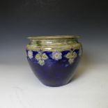 A Royal Doulton stoneware Jardinière, with blue ground and tubelined floral decoration, W 23 cm x