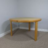 A modern light oak circular Table, with an interchangeable centre, to either a natural light oak