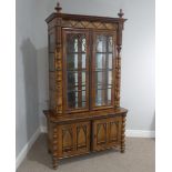 A Victorian Gothic style walnut display cabinet, with impressive decorative carved wooden designs