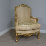 A giltwood Louis XVI style Armchair with upholstered seat and back, on claw feet, gold painted, W 78