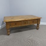 A late 20thC pine Coffee Table, rectangular top above three drawers, one small two large,