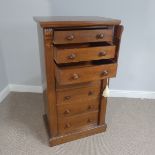 An early Victorian mahogany Wellington Chest, with seven drawers, carved brackets and turned