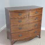 A Georgian mahogany bow-front chest of drawers, with two short drawers and three long drawers,