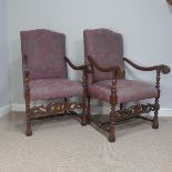 A pair of walnut reproduction Carolean style upholstered open Armchairs, having foliate mouldings to