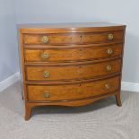 An Edwardian Sheraton Revival inlaid mahogany bow front Chest of Drawers, note damage to one side