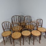 A Set of eight bentwood Dining Chairs, with cane seats upon bowed legs supported by curved