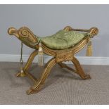 An Egyptian style gilt wood carved stool, with green and gold upholstered seat, chips to gilt paint,