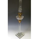 An unusual 19thC clear cut glass oil lamp, in the form of a Corinthian column, with brass capital