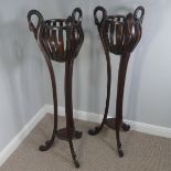 A Pair of mahogany torchere plant stands, with encased supports and carved swan decorations, does